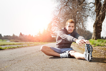 Mixed race man stretching
