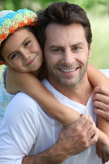 Fototapeta premium Girl on father's back