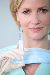 Female nurse holding syringe