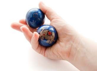The hand rotates two bright spheres