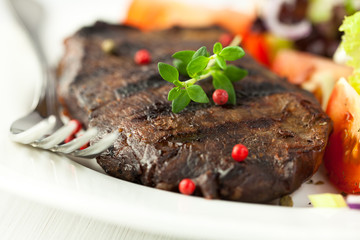 Grilled steak with thyme and peppercorns