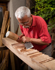 woodcarver working with mallet and chisel 8