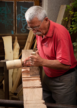 woodcarver working with mallet and chisel 3