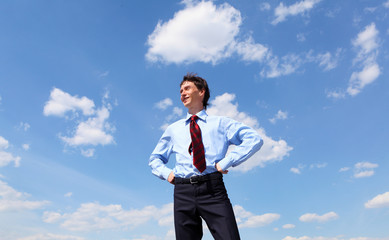 young business man in a blue shirt and red tie