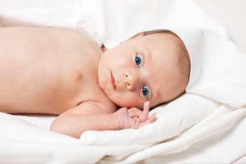 Picture of the newborn resting on a bed