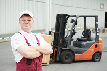 warehouse worker in front of forklift