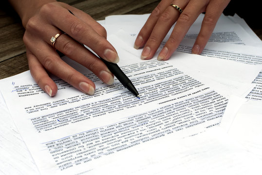 Close-up of female hands working with document