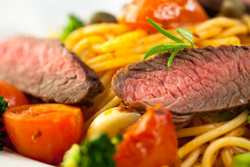 Closeup of rustic spaghetti with beefsteak