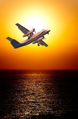 Fototapeta na wymiar airplane flight and the sunset