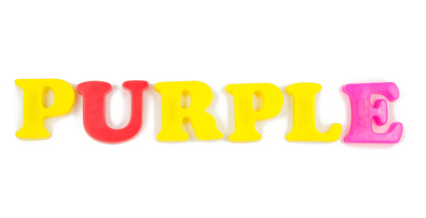 purple written with child's fridge magnets on white