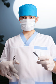 Surgeon working in operating room. Looking at camera. Bottom vie