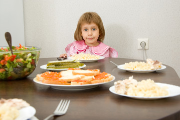 A little girl at the table.