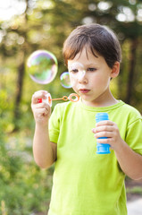 Little boy blowing bubbles