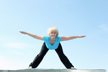Fototapeta premium Portrait of a senior woman doing yoga