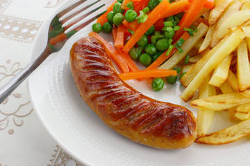 Sausage with french fries and vegetables