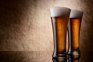 Beer into glass on a old stone