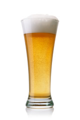 Beer into glass isolated on white