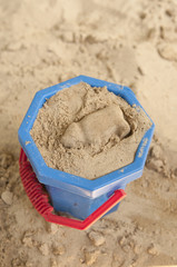 Blue bucket in sandpit