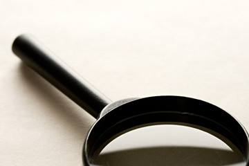 Magnifying glass isolated on the paper background.