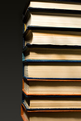 Stack of books isolated on the dark background