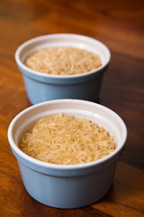 Two small pots of uncooked long grain rice