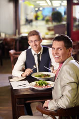 Two men having lunch in a restaurant