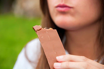 Woman tasting a chocolate bite