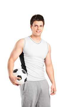 A male athlete holding a football