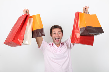 Man holding up shopping bags