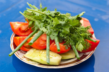 Fresh vegetables on a blue garden table