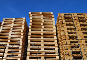 many wooden pallets placed in warehouse coutyard