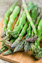 Fresh green asparagus on cutting board, closeup shot