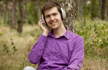 Men with headphones at the park.