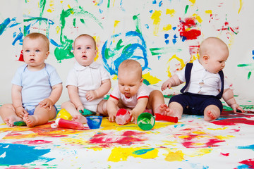 Babies playing with paints