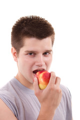 Young man eating apple