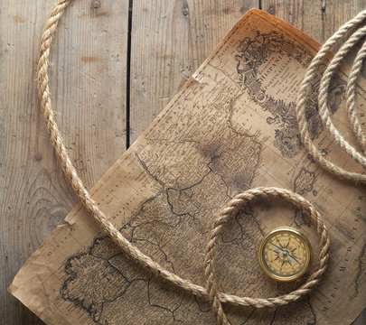 old compass and rope on vintage map 1732