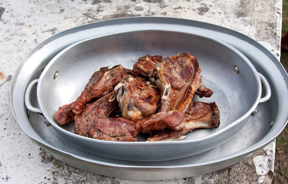 Braai with mutton chops in metal bowl cooked