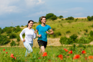 Young sportive couple is jogging outside