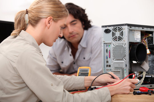 Woman fixing a hard drive