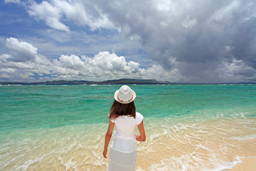 Fototapeta na wymiar 水納島の美しい海を眺める後姿の女性
