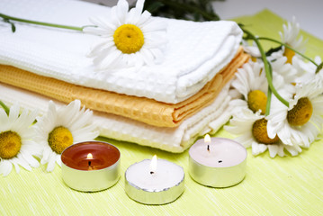 conflagrant candles with the flower of camomile