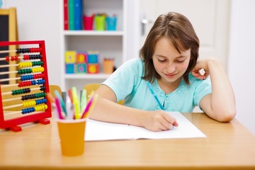 Teen girl practicing and doing homework