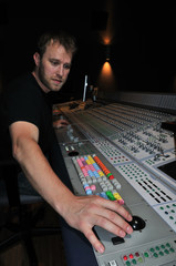 mixer working with the mixing console in sound studio