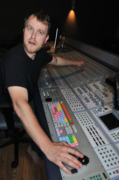 mixer working with the mixing console in sound studio