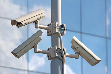 three security cctv cameras on the light pylon