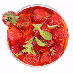 Jelly with strawberries decorated with a mint twig