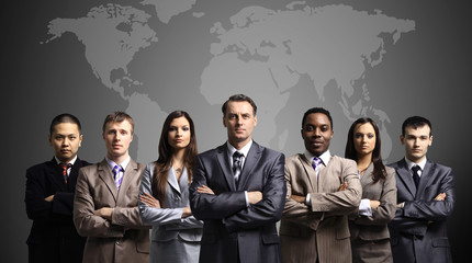 Businessmen standing in front of an earth map
