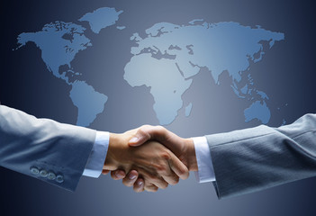 Handshake with map of the world in background