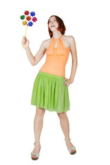 young girl in bright clothes holding pinwheel and smiling, isola