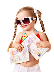 Child holding international passport and money.